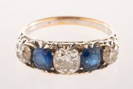 An antique diamond and sapphire five stone, claw and grain set with three old-cut diamonds,