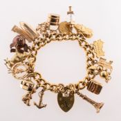 A charm bracelet with charms, a rolled gold charm bracelet with heart padlock and safety chain,