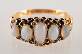 A Victorian five stone opal ring, set with five graduated oval opal cabochons,