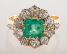 An emerald and diamond cluster ring,