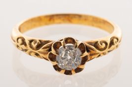 A Victorian diamond ring, claw set above an openwork scalloped edge gallery with an old-cut diamond,