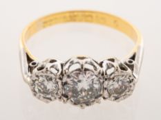 A three stone diamond ring, illusion set with three brilliant-cut diamonds,