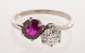An Art Deco ruby and diamond 'toi et moi' ring, of twist design, claw set with a circular-cut ruby,