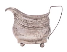 A George III silver milk jug, shaped oval form, on ball feet, with a gadrooned border,