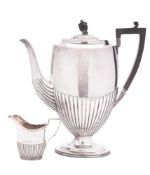An early 20th century silver coffee pot & matching milk jug, oval form,