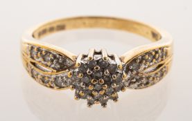 A 9ct gold diamond cluster ring, of cluster style with cross-over openwork shoulders,