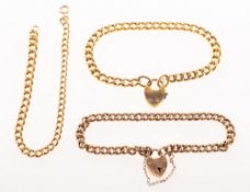 A group of three curb link bracelets, including a curb link bracelet with heart padlock,