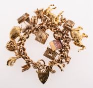 A charm bracelet with charms, a curb link bracelet with later added heart padlock and safety chain,