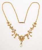 An Edwardian floral pearl necklace, barrel clasp and rope twist chain to a floral motif centrepiece,