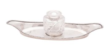 A George V silver inkstand, shaped oval outline,