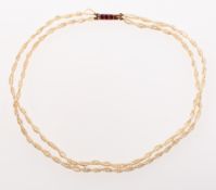 A double row of twisted seed pearls,