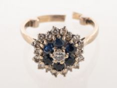 An 18ct white gold diamond and sapphire cluster ring, of flower head form,