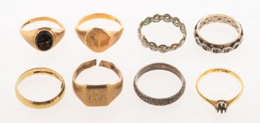 A group of eight rings, including three signet rings and a wedding band, (all mainly damaged/split),