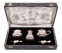 A 20th century Indian silver three-piece condiment set, oval form,