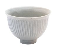*David Leach [1911 - 2005] a porcelain bowl of footed form with everted rim and fluted decoration
