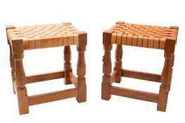 Workshop of Robert Mouseman Thompson (1876-1955): A pair of carved oak and leather footstools.