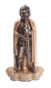 An enamelled cast iron fire iron companion stand modelled as a Mediaeval knight,