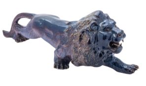 A porcelain figure of a lion under mottled blue purple glazes, 50cm long.