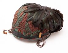 A 1950s Italian steel helmet. Having leather liner and canvas camouflage cover.