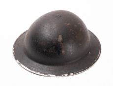 A British 1939 first pattern steel helmet. Finished in black with leather liner and canvas strap.