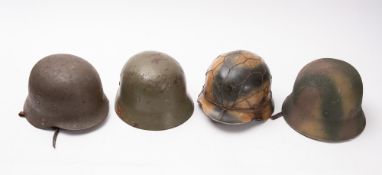 Four post WWII German steel helmets. All with leather liners and two stamped to the inside.