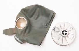 A WWII rubber gas mask. Serial number RHI38/4, in green with removable filter.
