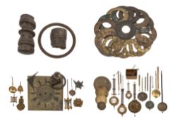 A collection of various brass clock chapter rings and pendulums, including a mercury filled example.