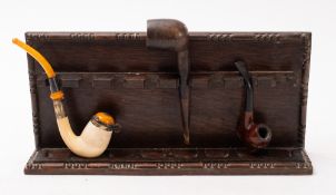 A silver mounted pipe with amber type handle.