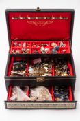 A quantity of various costume jewellery in a black jewellery case.