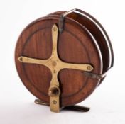 A 5 inch walnut and brass star back sea reel,