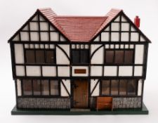 A late 20th Century dolls house in the style of a Tudor Manor.