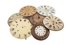 A collection of various wall clock dials, comprising enamel , glass and wooden examples,