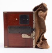 A Newman & Guardia mahogany and brass three quarter plate changing back,