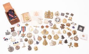 A mixed collection of WWII era cap badges.