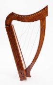 A Titan Celtic 19 string Harp. The line inlaid pillar and neck with carved body, in original bag.