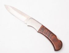A Crosscut oversize advertising folding knife, with two piece wooden grip, total length 43cm.