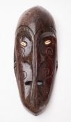 A 20th Century Oceanic Manam Islands carved wood mask.