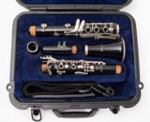 A Selmer CL300 clarinet. Having a black body with plated keys and in a fitted case.