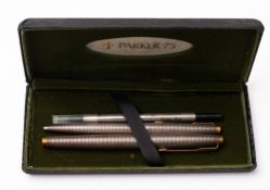 A Parker 75 sterling silver converter fountain pen and ball point set, Cisele with gold trim,