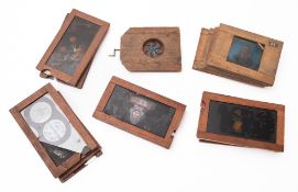 A collection of 18 mahogany cased magic lantern slides.