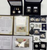 A collection of coins including Westminster commemorative sets, coin covers,
