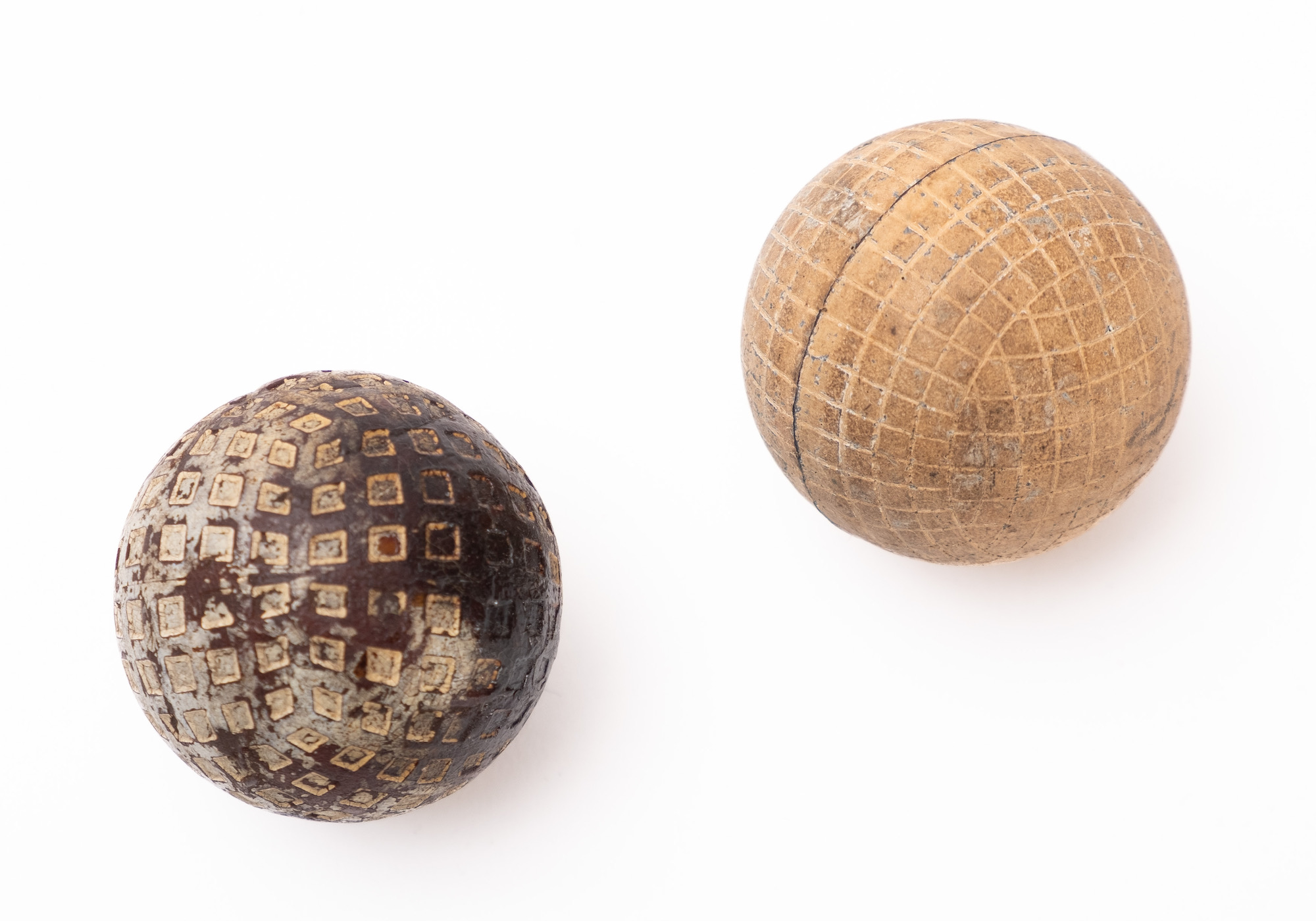 An early 20th century gutta percha golf ball and a Dunlop No.