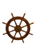 A 20th Century mahogany and brass ships helm. 95cm diameter.