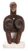 A Punu bellow, of traditional form , with carved face and elongated neck,