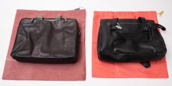 Two Radley leather handbags. Both in black with dust bags.