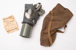 A 20th Century USA homefront gas mask. The rubber mask within a canvas bag and cardboard box.