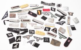 A collection of WWII German reproduction cloth badges. Together with six reproduction belt buckles.