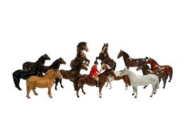 A collection of thirteen Beswick horse figures.