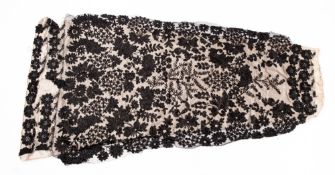 An early 20th century French? black beadwork and white silk dress or skirt panel, of floral design,