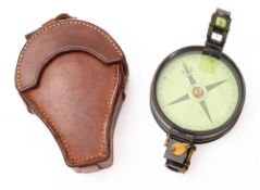 An early 20th century lacquered brass prismatic compass, unsigned, 2 1/2 inch paper dial,